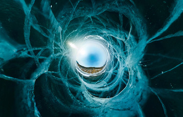 Wall Mural - Blue ice sphere covered with cracks on a blue background, the stereographic view of little planet