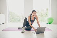 Full Body Photo Of Positive Sporty Girl Using Her Computer Browsing Internet Want Find Film Movies Video About Sport Fitness Sit On Purple Mat In Studio Like House Indoors