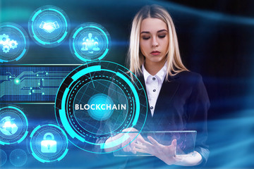 Business, Technology, Internet and network concept. Young businessman working on a virtual screen of the future and sees the inscription: Blockchain