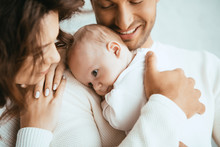 Cropped View Of Happy Man Holding Adorable Baby Near Smiling Wife