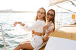© Drobot Dean - Pretty women friends outdoors on yacht in sea.