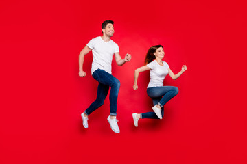 Poster - Turned photo of cheerful positive nice pretty cute couple boyfriend girlfriend wearing jeans denim white t-shirt smiling toothy footwear urgent for sales isolated over vivid color background