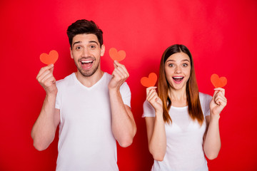 Poster - Photo of cheerful positive nice cute charming pretty couple boyfriend girlfriend smiling excited about receiving postcards showing small heart shapes isolated in white t-shirt vivid color background