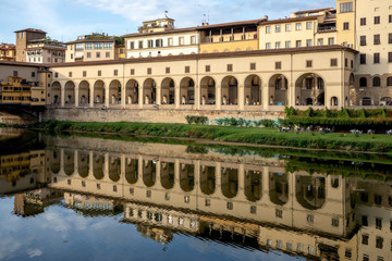 Wall Mural - FLORENCE, TUSCANY/ITALY - OCTOBER 18 : View of buildings along and across the River Arno in Florence  on October 18, 2019. Unidentified people.