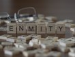 The concept of Enmity represented by wooden letter tiles