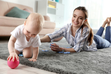 Sticker - Adorable little baby crawling near mother at home