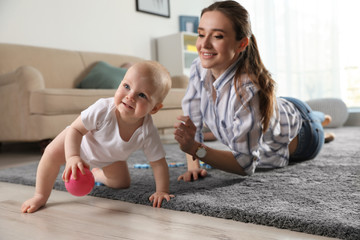 Canvas Print - Adorable little baby crawling near mother at home