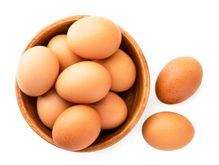 Wall Mural - Chicken eggs in a wooden plate on a white. The view of the top.