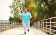 © New Africa - Young overweight man running outdoors. Fitness lifestyle