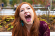 © Mat Hayward - young woman laughing hysterically in autumn park