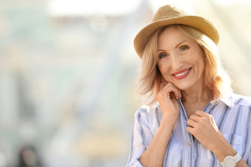 portrait of happy mature woman on city street