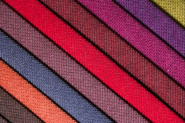 Wall Mural - Colorful and bright fabric samples of furniture and clothing upholstery. Close-up of a palette of textile abstract diagonal stripes of different colors