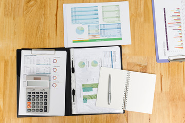 Wall Mural - Top view of business charts or graphs, calculatornotebook and pen on desk.