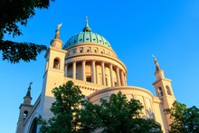 Beautiful Low Angle Shot Of The Church Of Saint Nicholas In Potsdam Surrounded By Green Trees