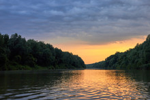 Beautiful Bright Dramatic Sunset Over Danube River With Forest Along Riverside