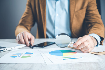 Wall Mural - man hand magnifier with document on desk