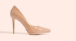 Closeup beige women patent leather shoe isolated on pink background. Stilettos shoe type. Summer fashion and shopping concept. Luxury, glamour party ladies wardrobe accessory. Selective focus. Banner