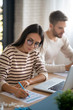 © zinkevych - Wife wearing glasses filling tax declaration sitting near husband