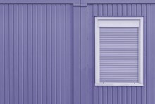 Beautiful Shot Of A Purple Metal Garage Wall With A White Window With Blinds