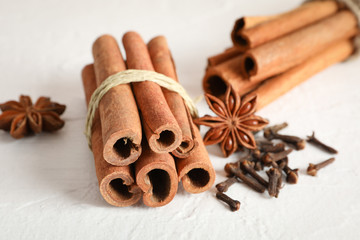 Poster - Cinnamon sticks and anise on white background, space for text