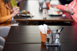Salt shaker pepper napkins on a table in a cafe
