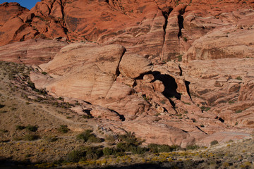 Wall Mural - Hikers on a trail at the base of Aztec Sandstone cliffs of Red Rock Canyon in Nevada