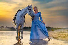 Blonde With A Horse Near The Water At Sunset