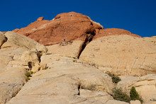 Two Climbers Descend A Sheer Cliff Of Aztec Sandstone In Red Rock Canyon In Nevada