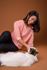 Wall Mural - Portrait of beautiful multi ethnic woman with pet cat