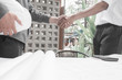 © I Believe I Can Fly - engineer,young engineers partners shaking hands after complete agreement building project outside the office, Engineer concept, success concept