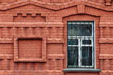 Fragment Of The Facade Of An Old Building Of Curly Red Brick With A Window