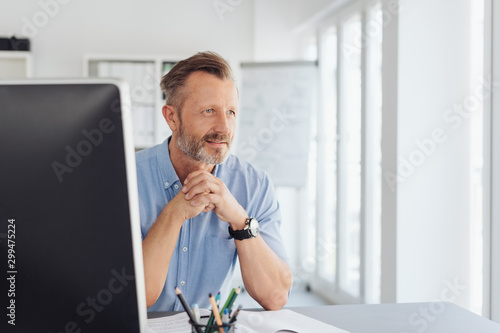 Fotografía Thoughtful businessman staring through a window