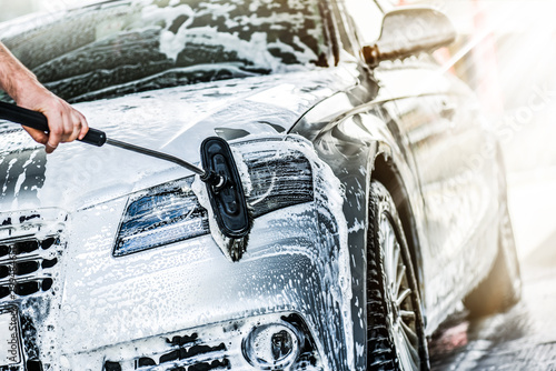 Fotomural Manual car wash with brush and pressurized water in automobile washing station