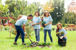 © Viktoriia - Volunteering. Young people volunteers outdoors planting together digging ground cheerful