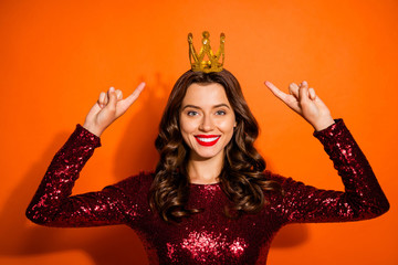 Wall Mural - portrait of charming luxurious prom queen beauty girl point index finger her golden tiara direct roy
