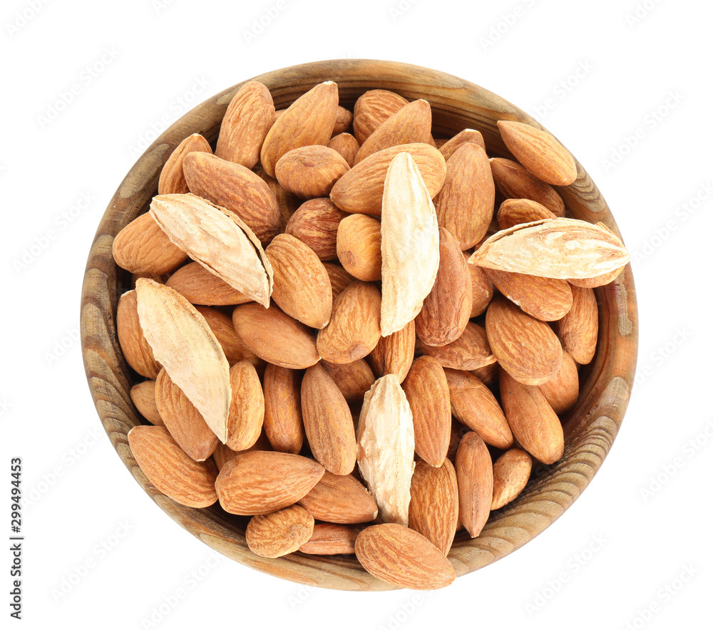 Plate with tasty almonds on white background