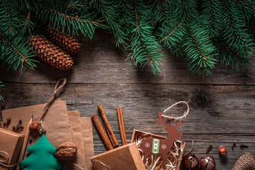 Wall Mural - Christmas green frame from fir branches on a vintage gray board background. Frame of fir branches. Christmas card blank.