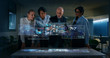 © Kitreel - A group of designer are using a futuristic sophisticated technology screen with augmented reality holograms for a new worldwide global project realization in an office.