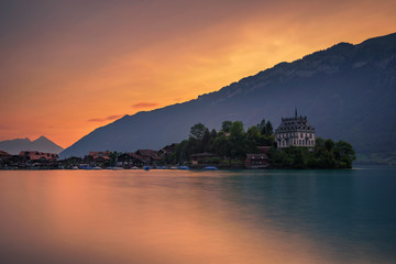 Wall Mural - Sunset above Iseltwald peninsula and former castle in Switzerland