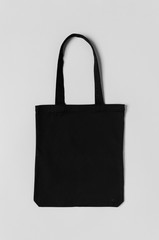 Wall Mural - Black tote bag mockup on a grey background.