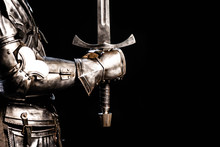 Cropped View Of Knight In Armor Holding Sword Isolated On Black