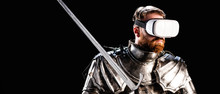Panoramic Shot Of Knight With Virtual Reality Headset In Armor Holding Sword Isolated On Black