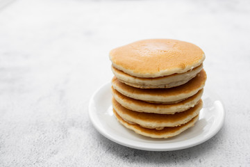 Pile of american clasic pancakes breakfast or snack, isolated on white background, copy space for text.