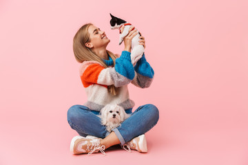 Cute lovely girl wearing sweater sitting with legs crossed