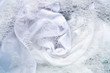 Soak white clothes in powder detergent water dissolution. Laundry concept