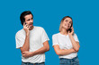 © ianachyrva - Blond woman and brunet man in white tees and blue jeans are talking on the phone.