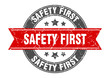 safety first round stamp with red ribbon. safety first