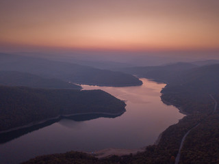 Wall Mural - Beautiful drone shot over twists and turns of a river in Rhodope Mountains, Bulgaria. Magical light and a beautiful sunset.