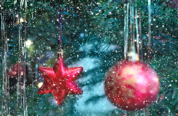 Christmas tree with red star and ball .Snowfall background.