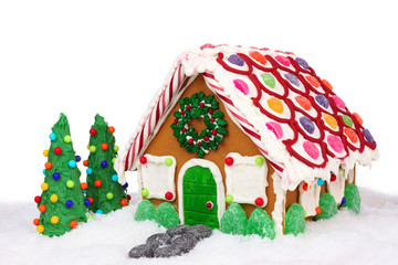 Christmas gingerbread house in snow isolated on a white background